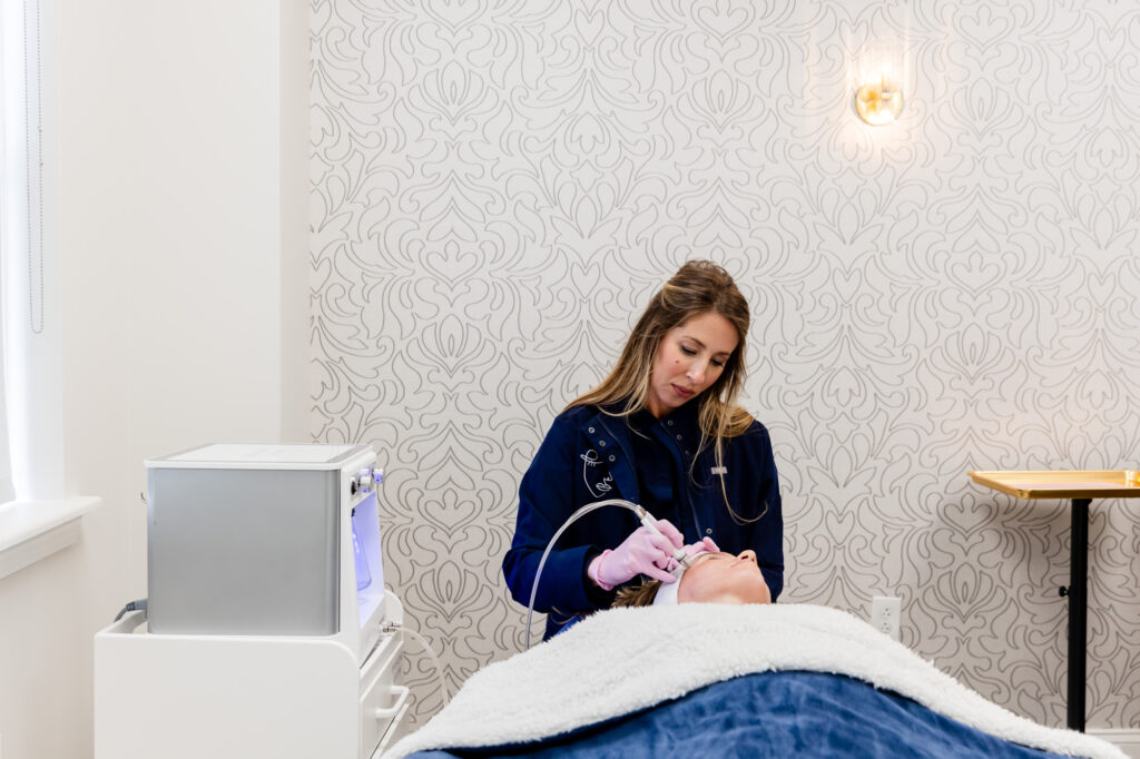 A provider at About Face Aesthetics conducts a DiamondGlow advancd spa facial in Philadelphia.