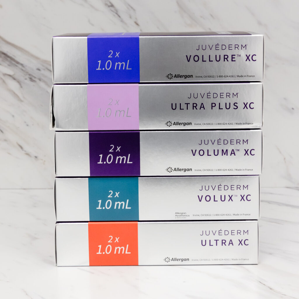 A stack of Juvederm filler choices rest on a marble surface. These shiny boxes represent About Face's options for Botox & fillers near Rittenhouse Square.