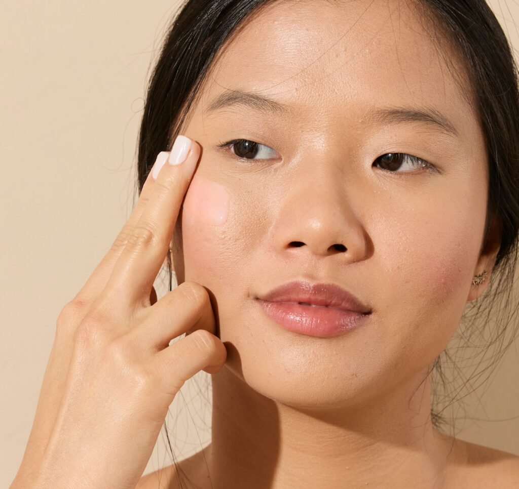 Woman checking her reflection and looking at lines and wrinkles.